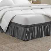 Corner of a bed with a polyester wrap around bed skirt on it
