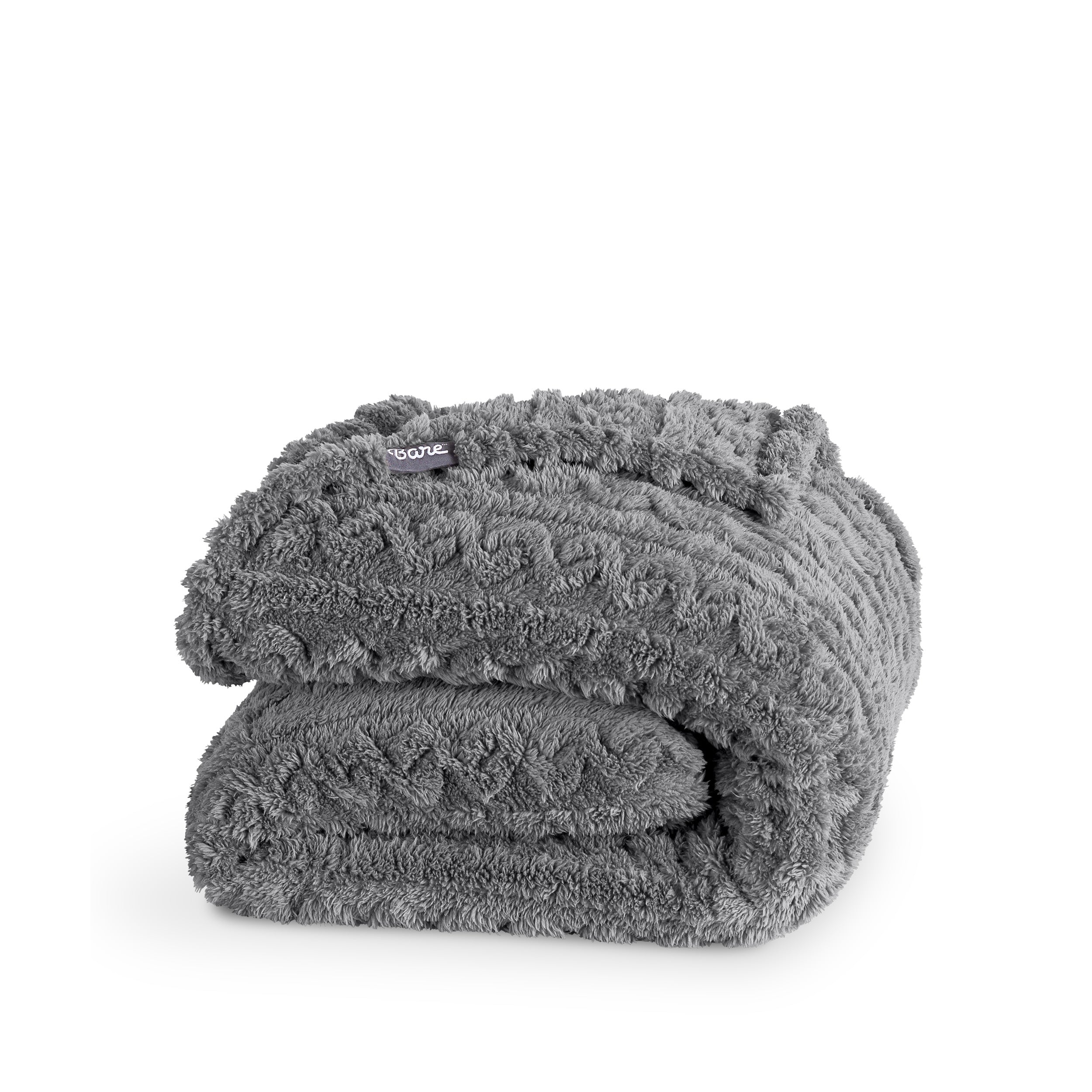 A cable knit sherpa blanket folded neatly