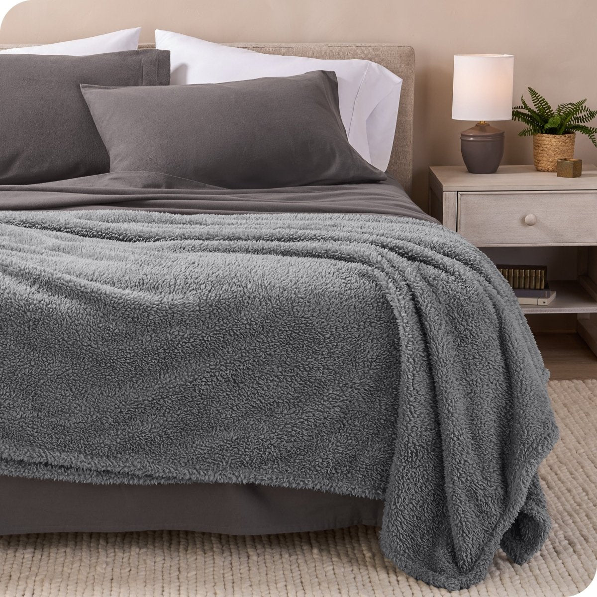 A double sided sherpa blanket on a bed