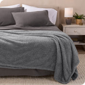 A double sided sherpa blanket on a bed