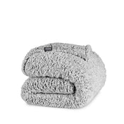 A tipped sherpa blanket folded neatly