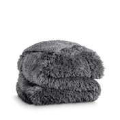 A shaggy faux fur blanket folded