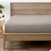 A mattress with just a fitted sheet on it