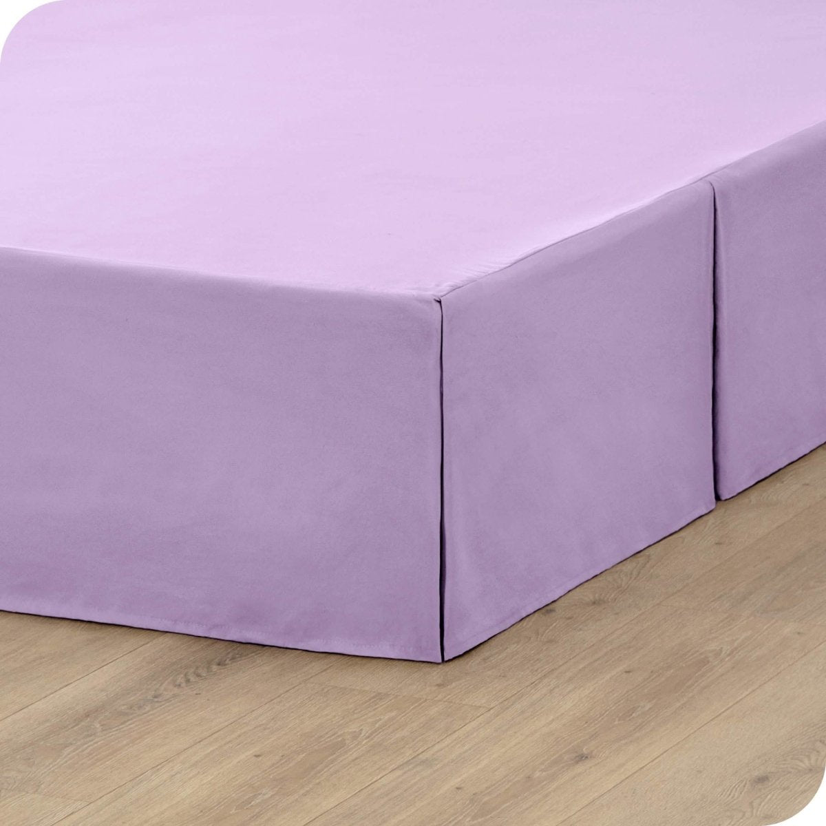A box spring with a bed skirt on it