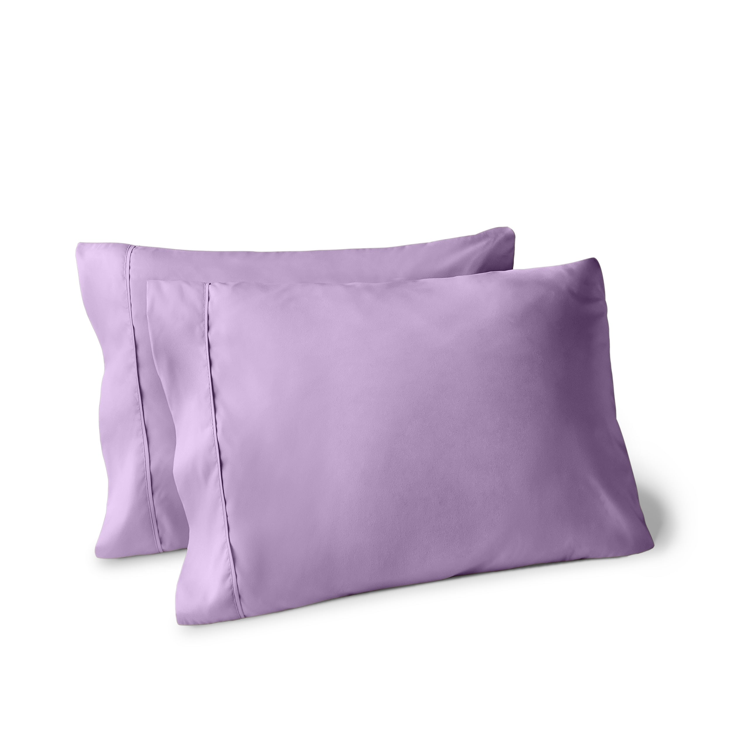 Two pillows on a white background with pillowcases on them