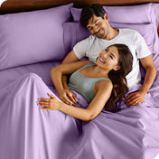 A smiling couple in bed