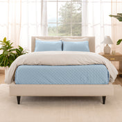 A bright bedroom with a coverlet set on the bed