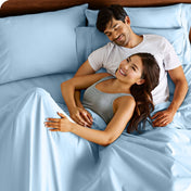 A smiling couple in bed