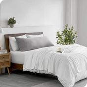 A body pillowcase on a pillow on a bed in a modern bedroom