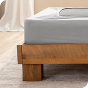 Close up of the corner of a bed frame with a cover box spring