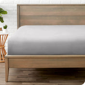 A mattress with just a fitted sheet on it