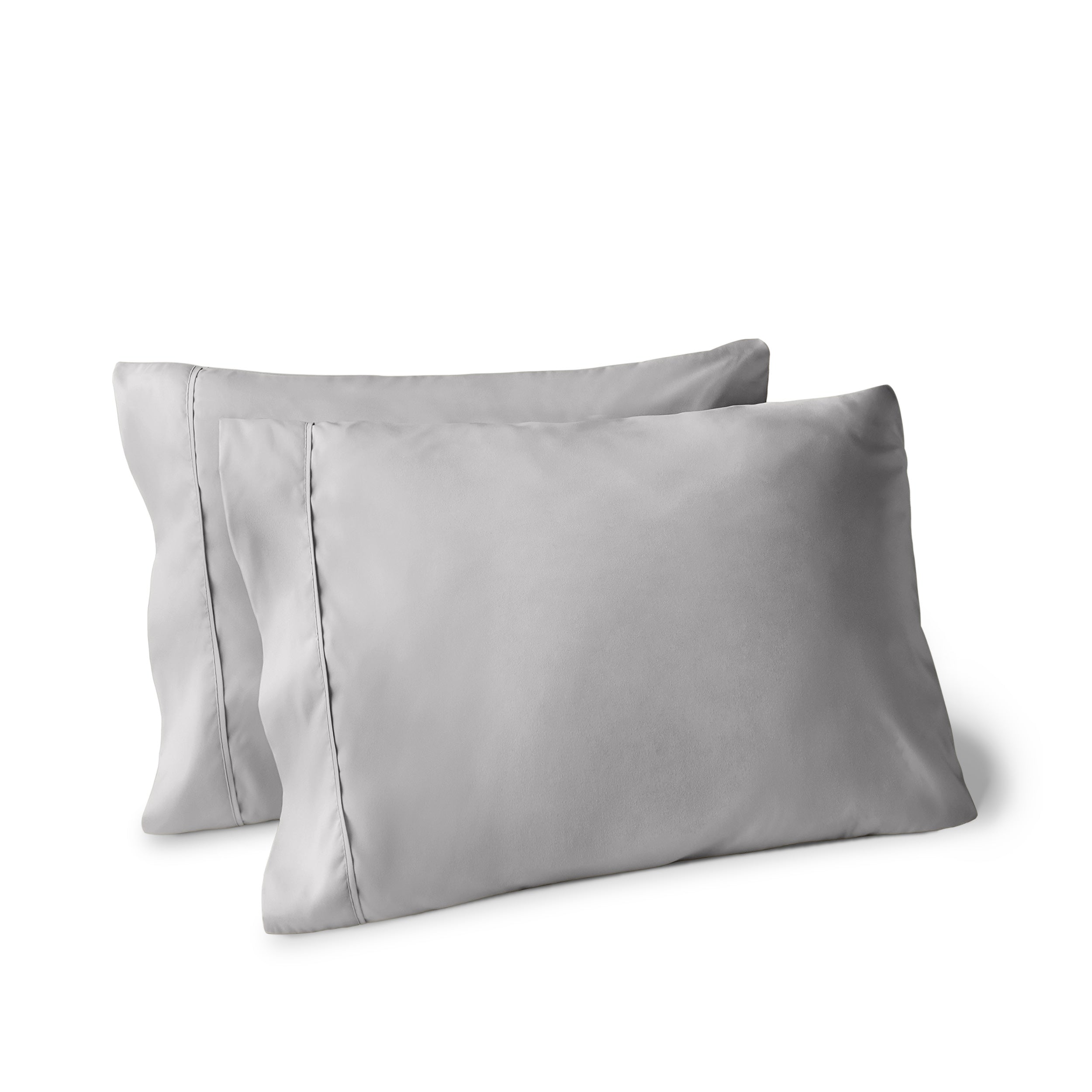 Two pillows on a white background with pillowcases on them