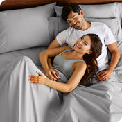 A smiling couple in bed