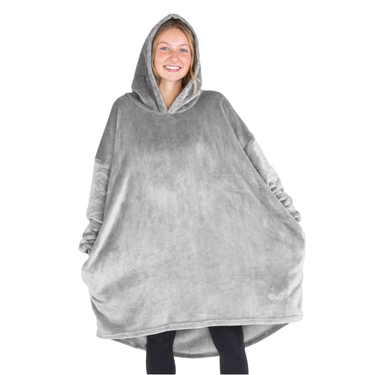 A woman wearing a cozy hooded blanket