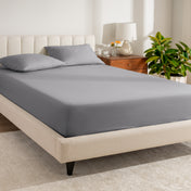 A bed made with a percale fitted sheet
