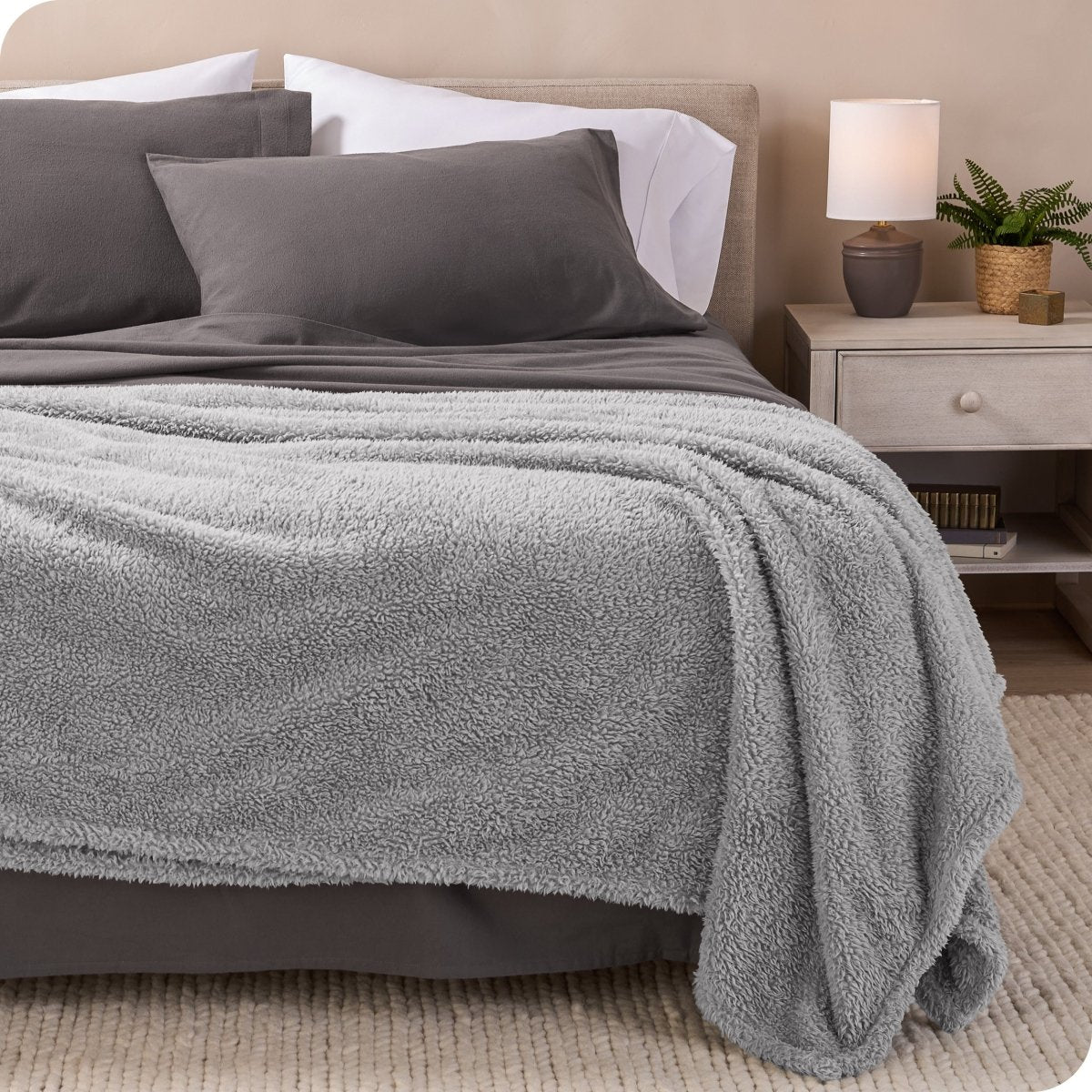A double sided sherpa blanket on a bed
