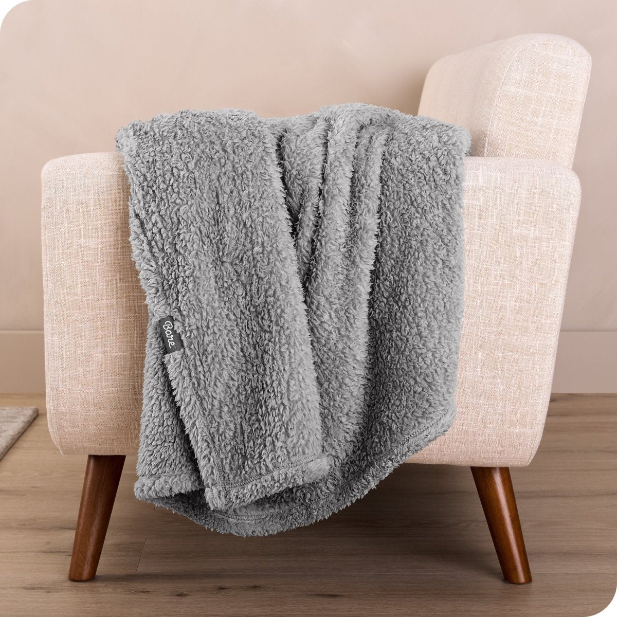 A sherpa blanket draped over a chair