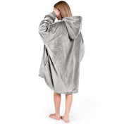 An adult with a hooded wearable blanket on