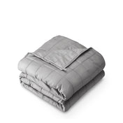A folded cotton weighted blanket with a white background