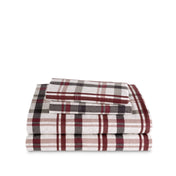 Stack of flannel sheets and pillowcases on a white background