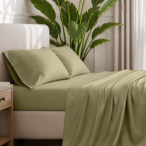 Ultra-soft sheets and pillowcases on a bed with a plant in the background