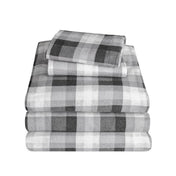 Stack of flannel sheets and pillowcases on a white background