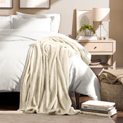Microplush blanket draped over the corner of a bed