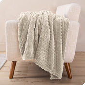 A microplush blanket draped over a chair