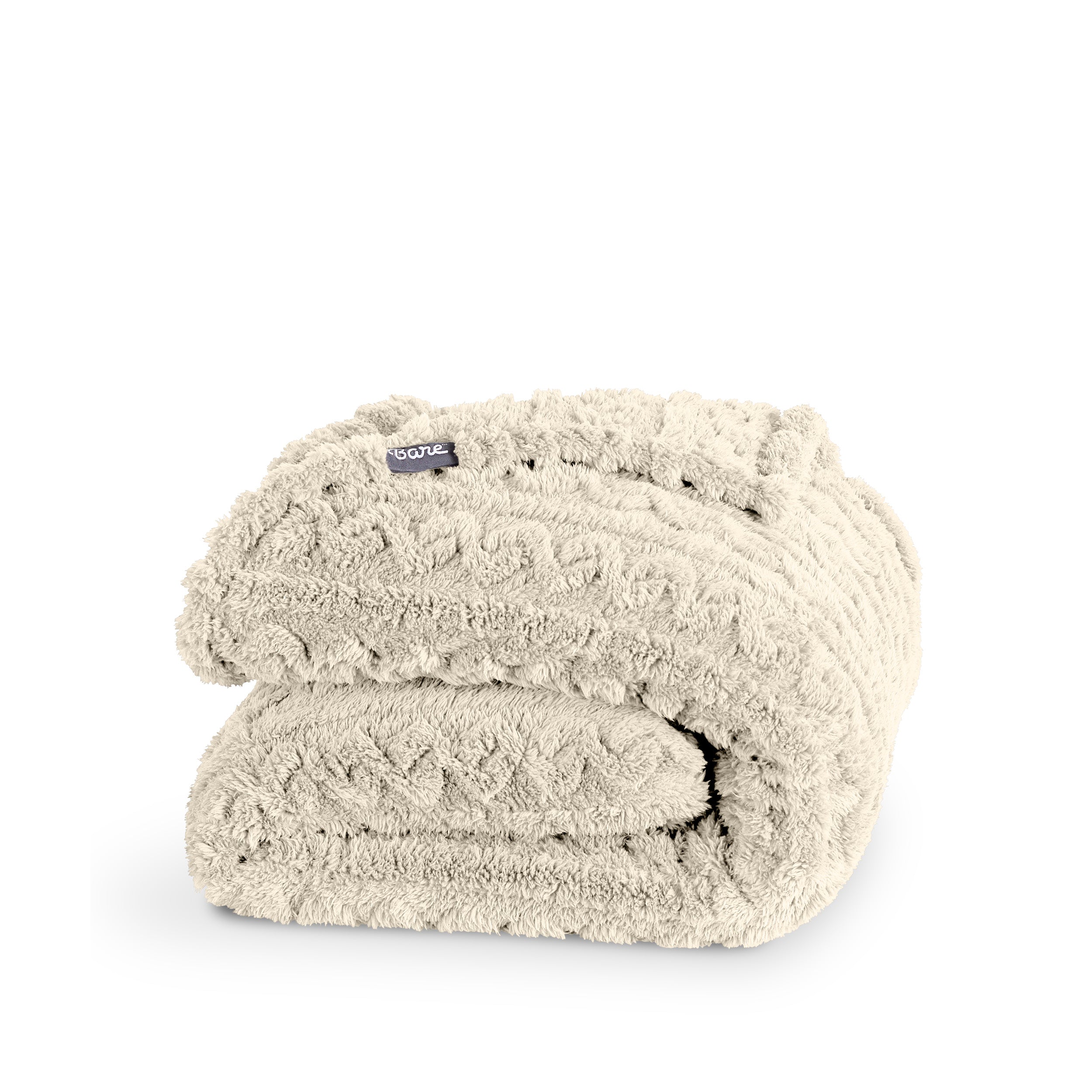 A cable knit sherpa blanket folded neatly