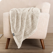 A sherpa blanket is hanging over the edge of a chair
