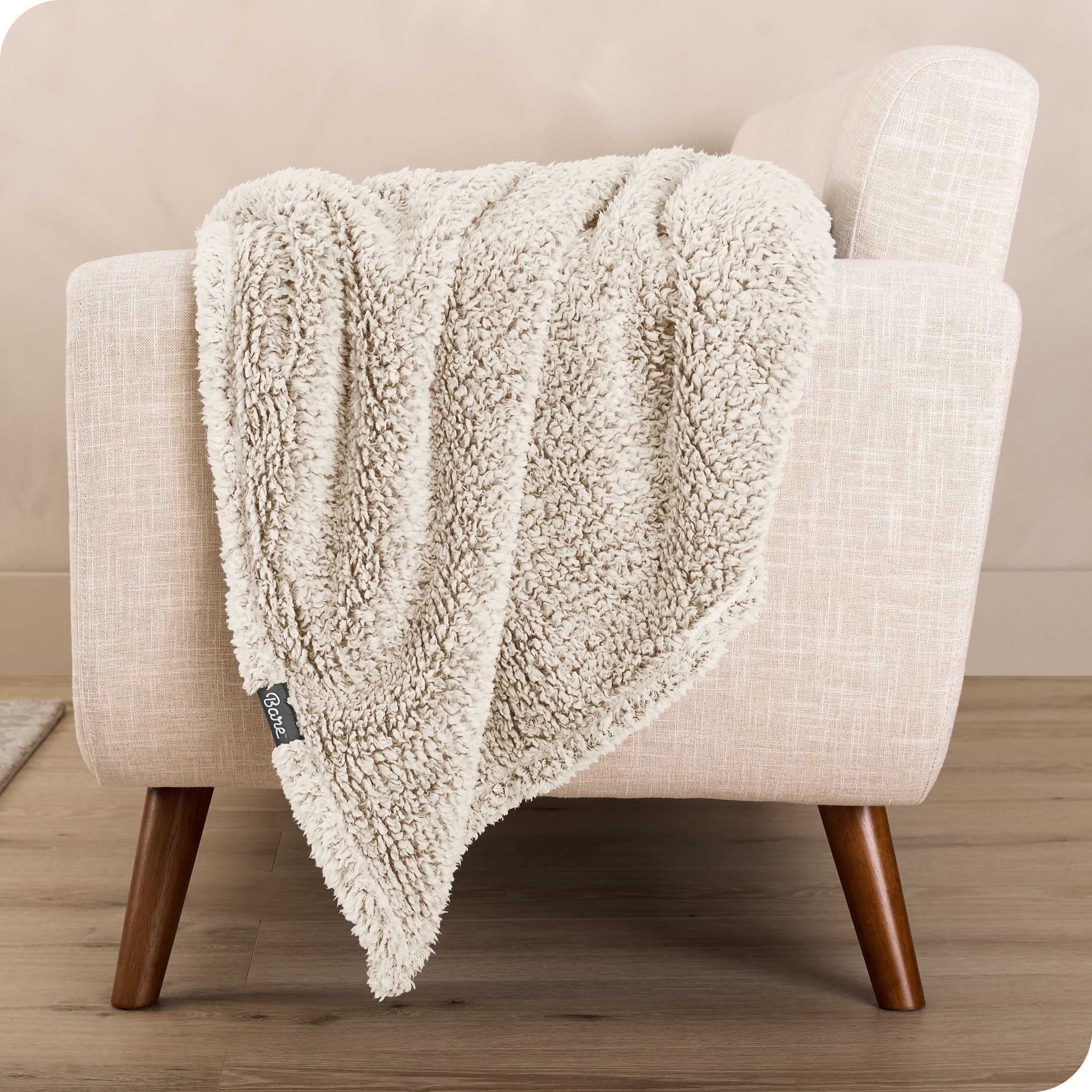 A sherpa blanket is hanging over the edge of a chair