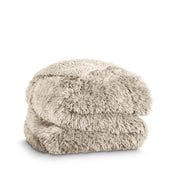 A shaggy faux fur blanket folded