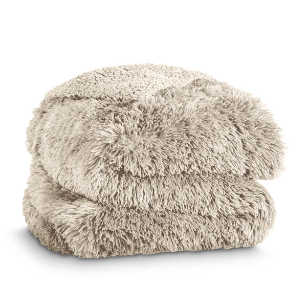 A shaggy faux fur blanket folded neatly