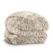A shaggy faux fur blanket folded neatly