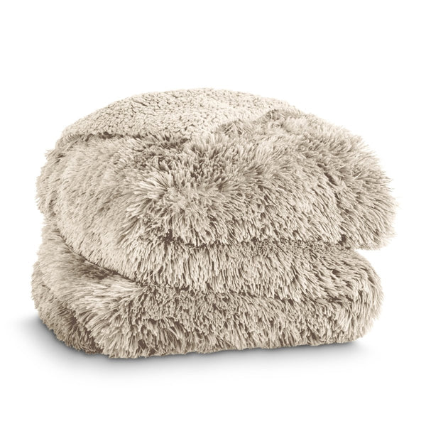 A shaggy faux fur blanket folded neatly