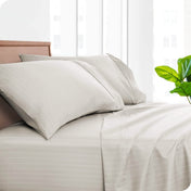 Printed pillowcases and matching sheets on a bed