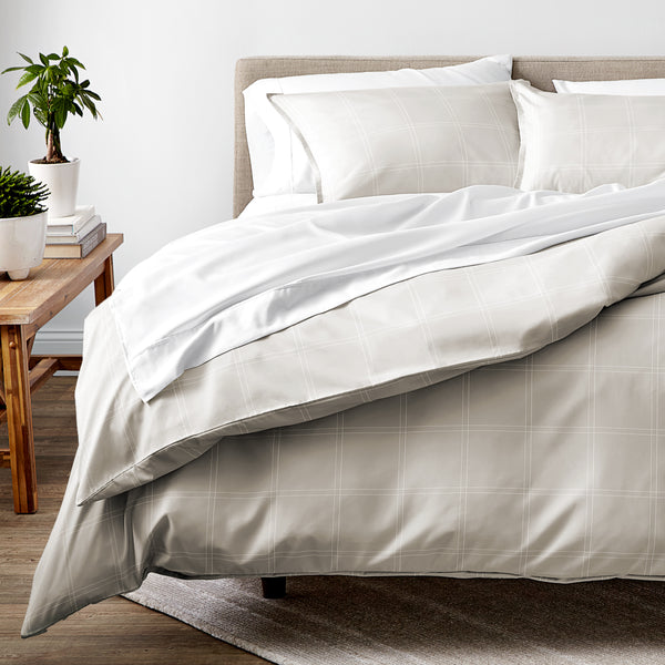 Duvet set on a bed with plants in the background.
