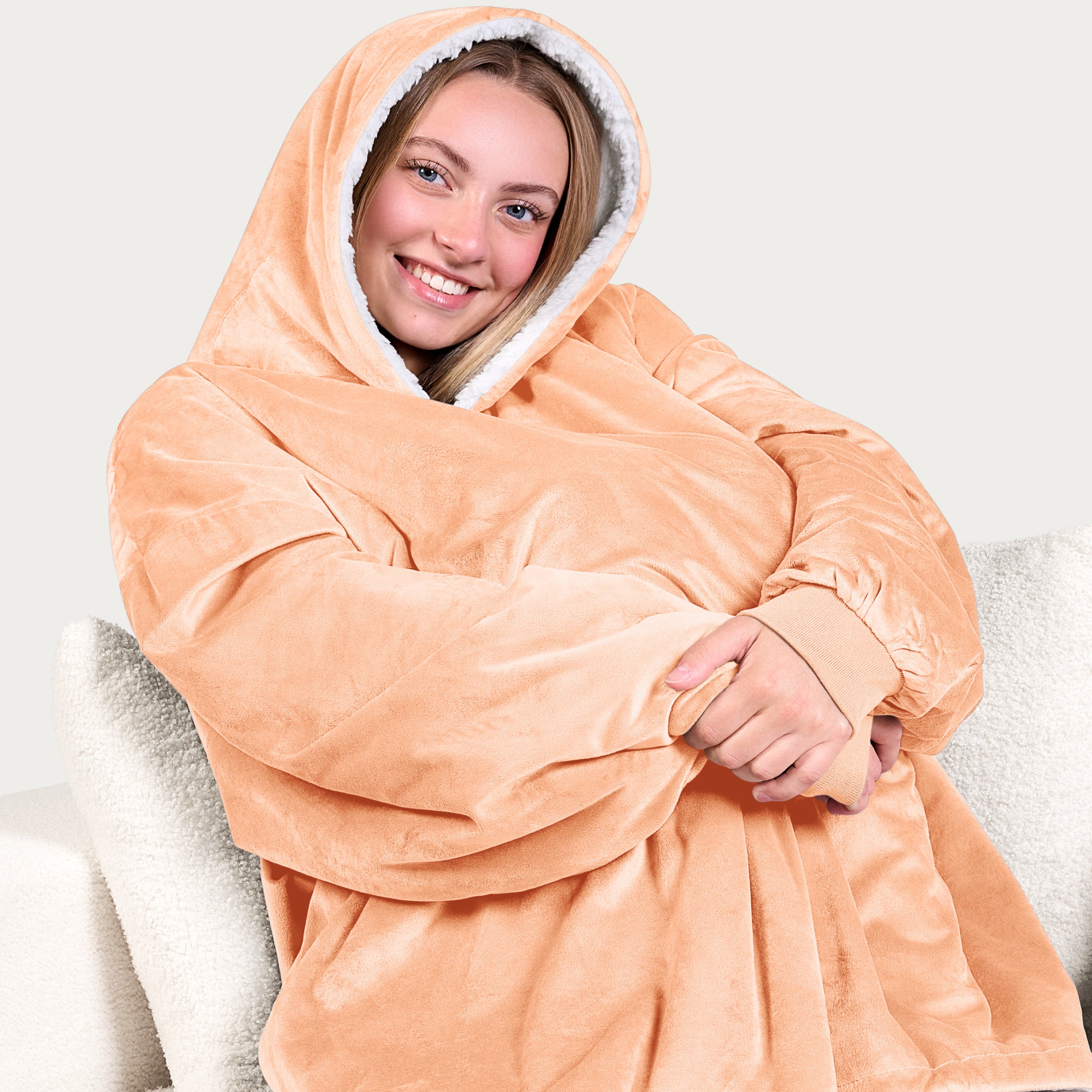 An adult with a sherpa wearable blanket on