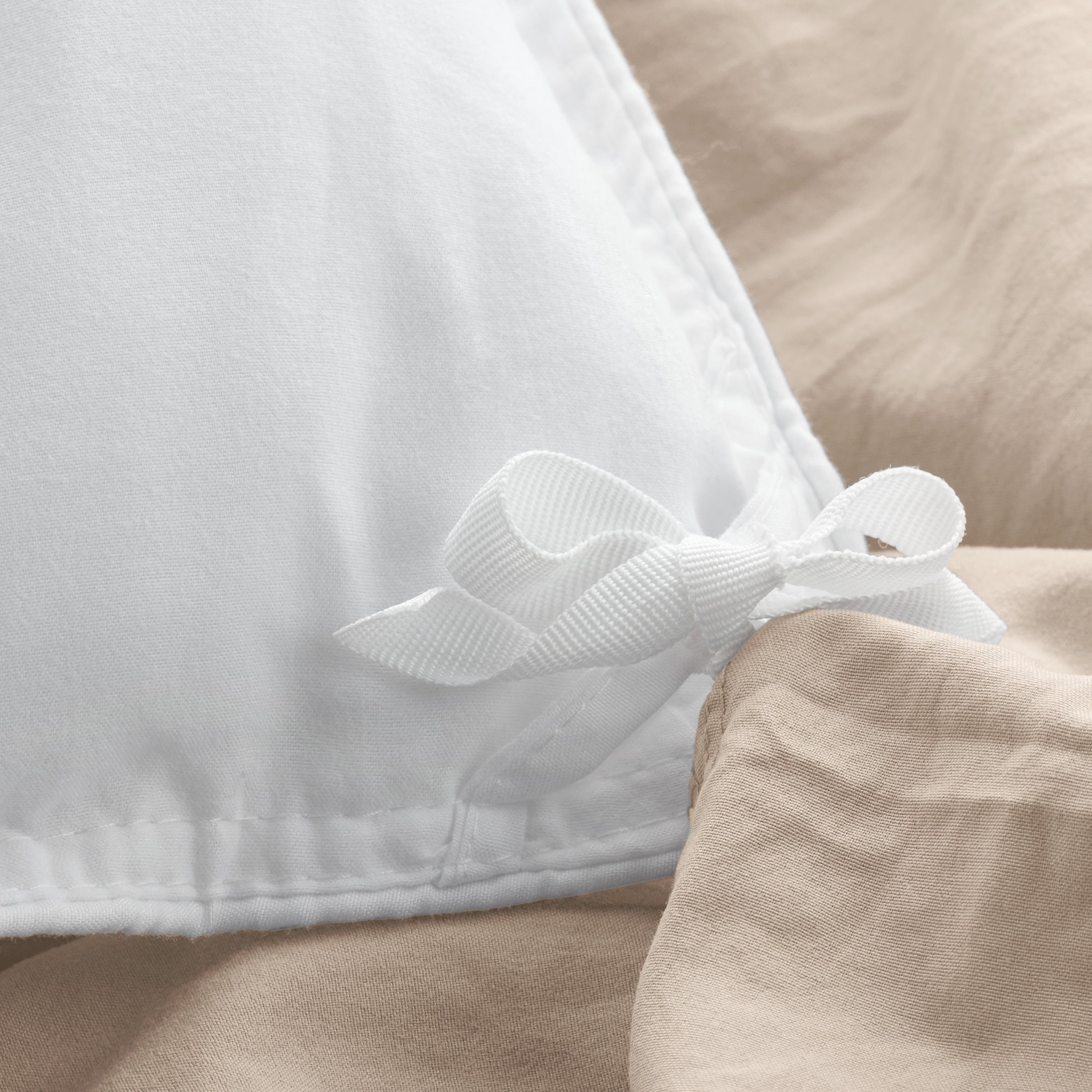 Close up of the corner ties on a duvet cover for attaching a duvet insert