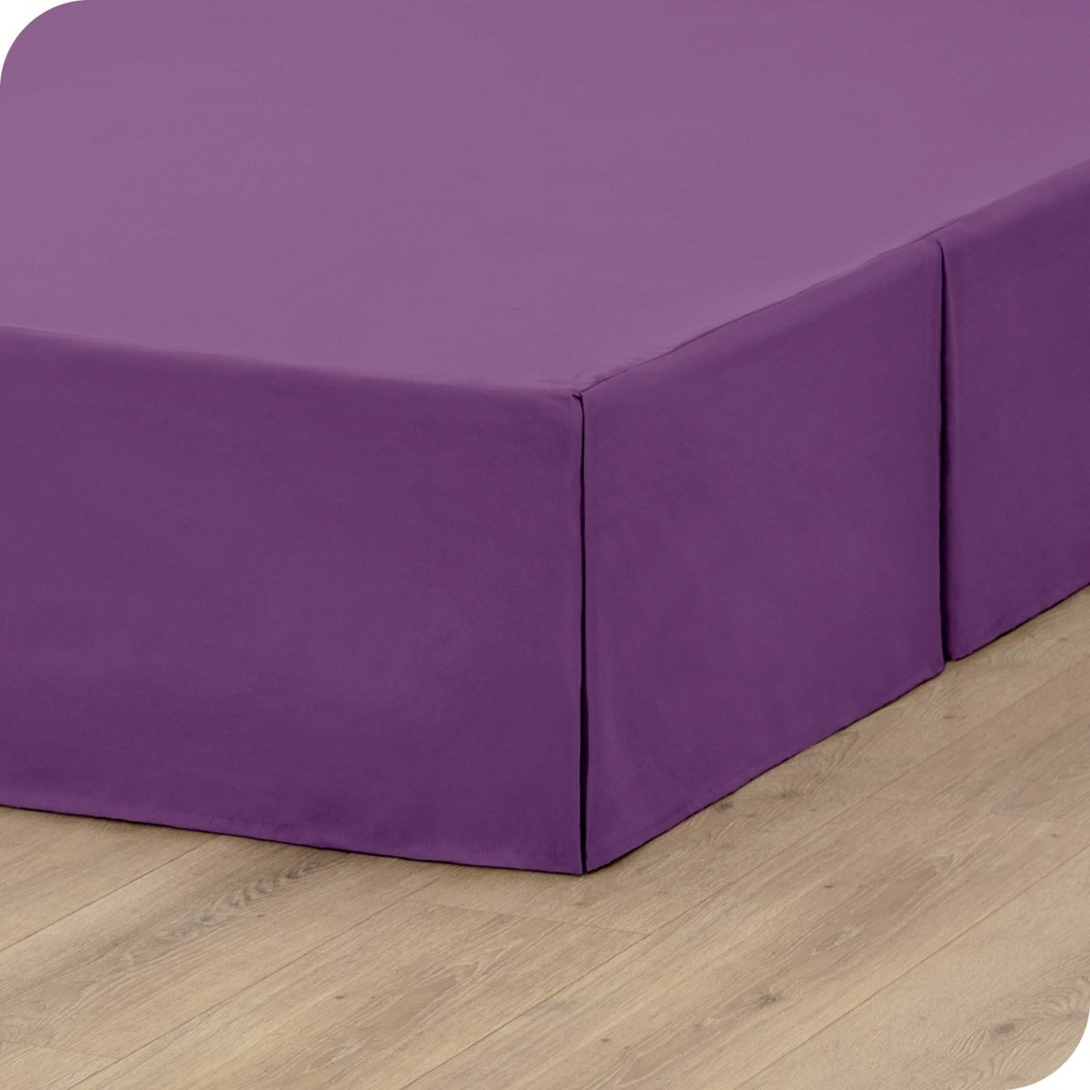 A box spring with a bed skirt on it