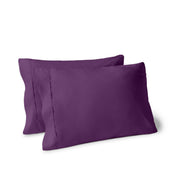 Two pillows on a white background with pillowcases on them