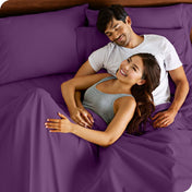 A smiling couple in bed