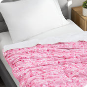 A weighted blanket laid out on a bed.