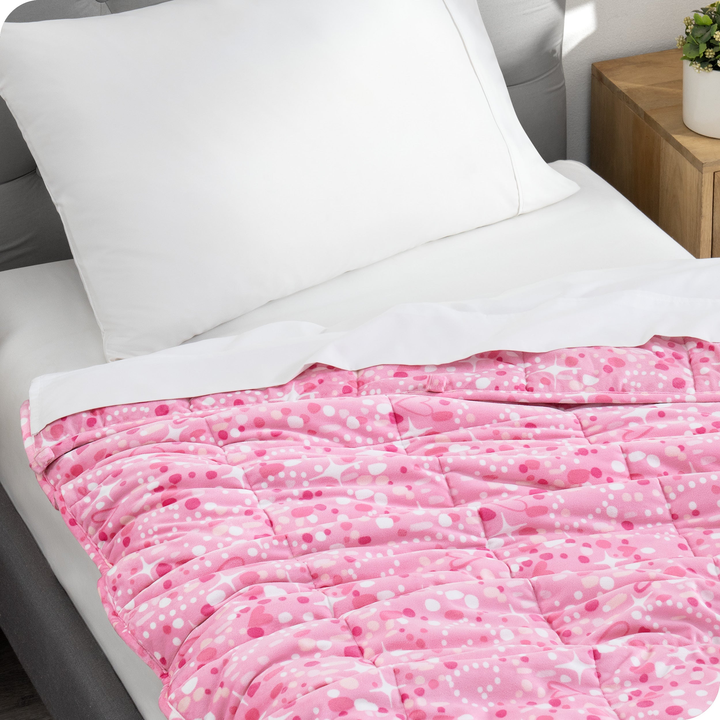 A weighted blanket laid out on a bed.