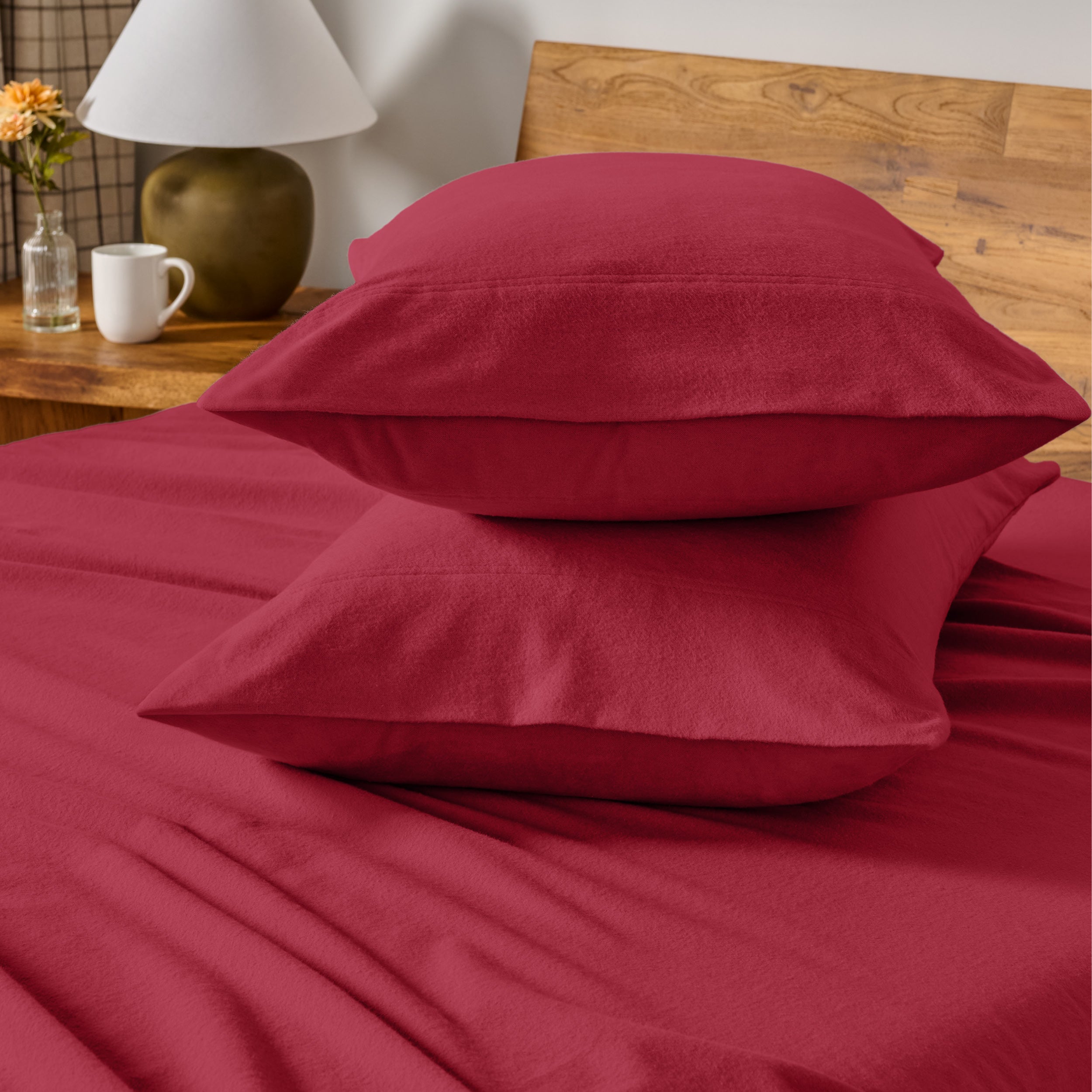 Flannel bedding set on a bed with a beige headboard and lamp.