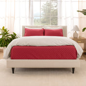 A bright bedroom with a coverlet set on the bed