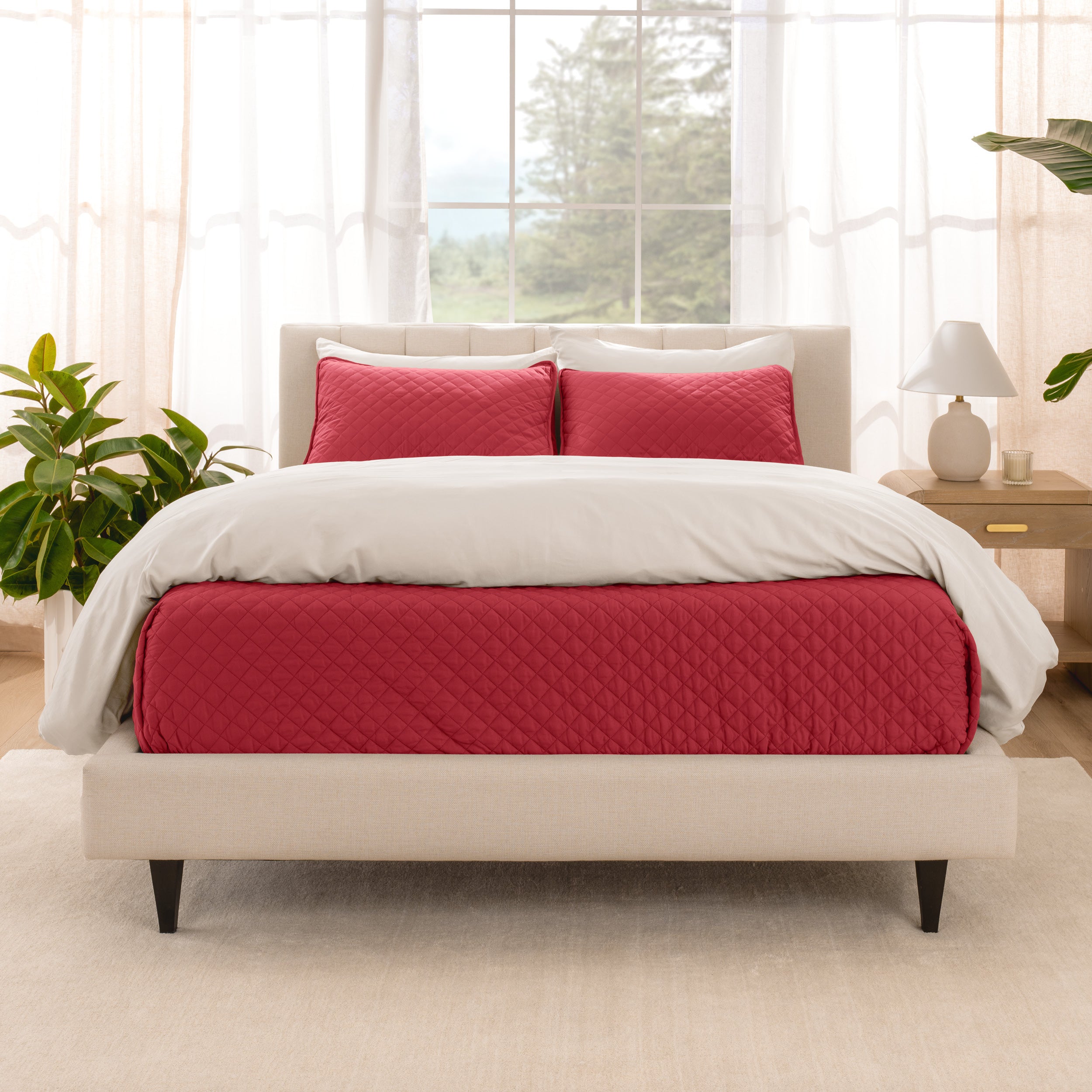 A bright bedroom with a coverlet set on the bed