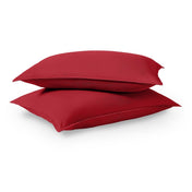 Two pillows stacked on a white background