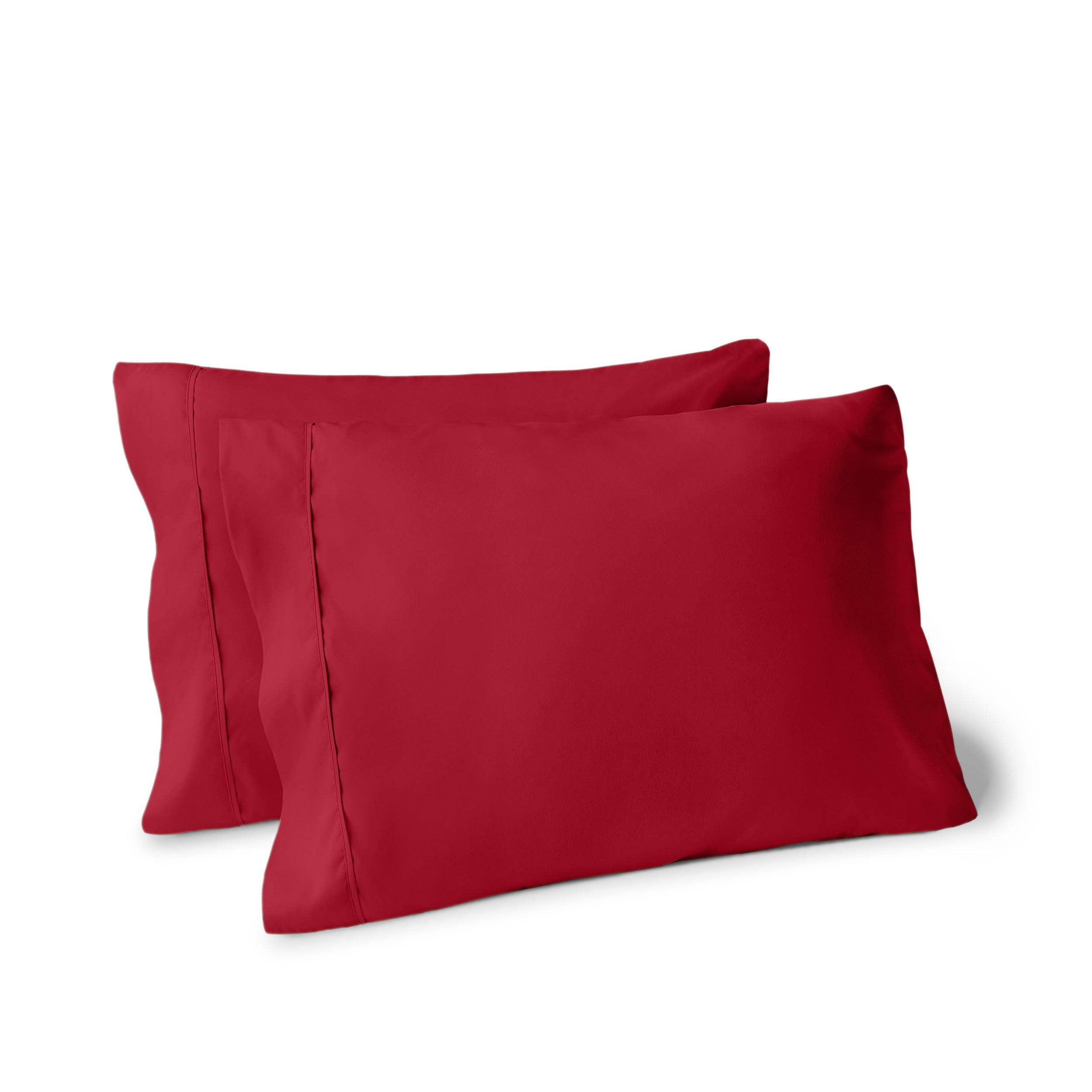 Two pillows on a white background with pillowcases on them