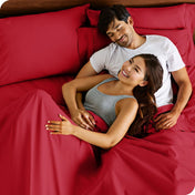 A smiling couple in bed